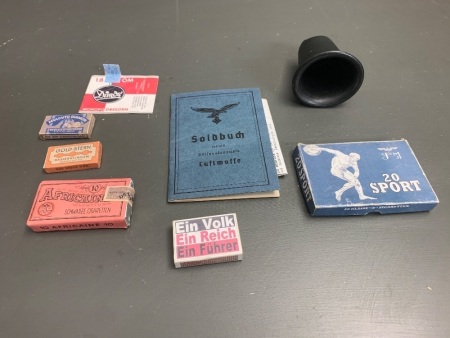 Asstd Lot of German WW 2 Luftwaffe Personal Effects - Soldbuch (pay book), Razor Blade Box x 2 (empty), Matchbox (with matches), Cigarette Box (20 Sport) Opened, Cigarette Box (Africain) Unopened, Water Bottle Cap