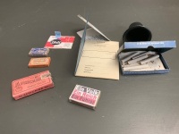 Asstd Lot of German WW 2 Luftwaffe Personal Effects - Soldbuch (pay book), Razor Blade Box x 2 (empty), Matchbox (with matches), Cigarette Box (20 Sport) Opened, Cigarette Box (Africain) Unopened, Water Bottle Cap - 2