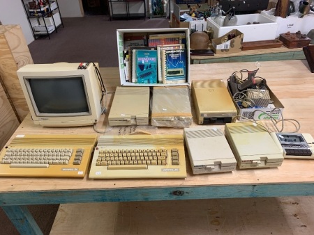 Large Quantity of Vintage Commodore Computer Eqpt inc. 2 x 64 Personal Computers - 2 x 1571 Disk Drives - 2 x 1541 II Disk Drives, 1 x 154l Disk Drive, 1 x 1084S-2 Monitor, 2 x Joystick, 1 x C2N Cassette Player, Power Packs, Cords and Books