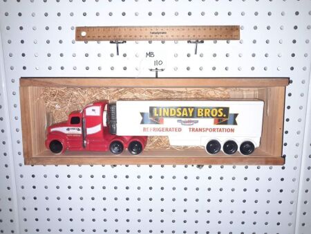 LINDSAY BROS' TRANSPORT, FULL (NEW CONDITION) PRIME MOVER TRAILER PORT DECANTER. UNUSED. NEW CONDITION. WOODEN DISPLAY BOX WITH PERSPEX SLIDING FRONT (PERSPEX HAS PROTECTIVE WRAP). NOW 'LINDSAY TRANSPORT' NOT 'LINDSAY BROS' - CONDITION NEW