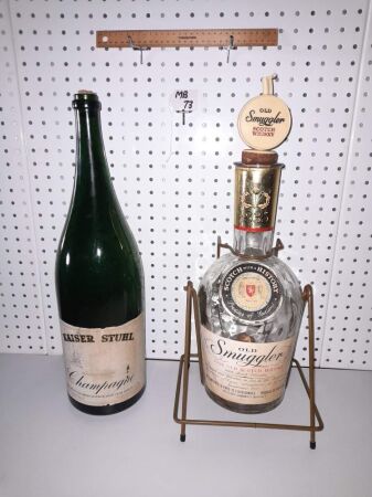 VINTAGE 'OLD SMUGGER' SCOTCH WHISKEY CRADLE / BOTTLE AND EMBOSSED POURER - 560 HIGH, 6 PINTS. KAISER STUHL CHAMPAGNE MAGNUM. - CONDITION GOOD