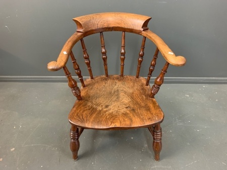 Antique Elm Low Captains Chair with Single Piece Seat and Spindle Carved Back