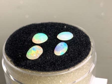 4 small high-dome Ovals Solid Coober Pedy Opals total 0.95 ct. Nice colours in all, mainly blues and greens