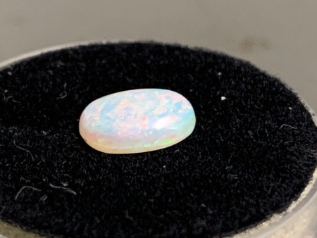 0.85 ct Solid Black Lightning Ridge Opal 8 mm x 6.5 mm Oval. Good variety of Red and Green colour