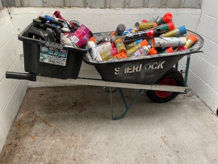 Wheel barrow with various aerosol cans and assorted chemicals in tub 