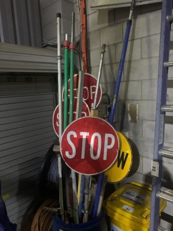 Bucket of various concreting tools and traffic signs