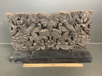 Carved wooden frieze panel on stand