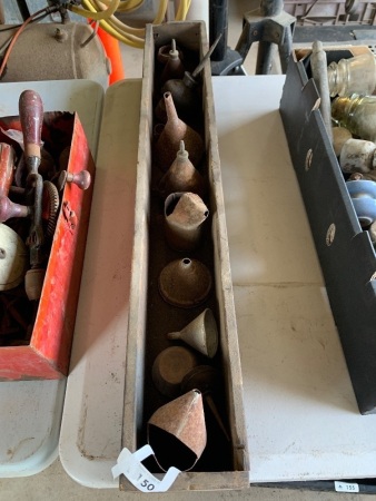 Long timber box containing assorted small oil tins, funnels etc