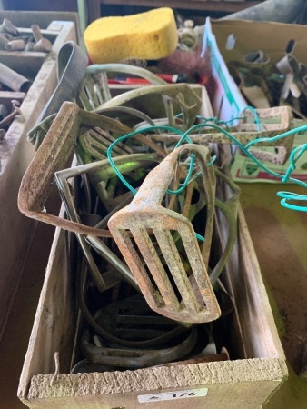 Timber box containing various steel and brass stirrup irons