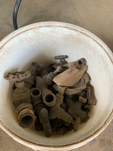 Bucket of brass and steel taps