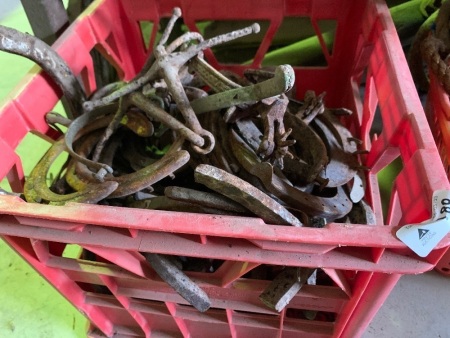 Crate of horse shoes, plus some spurs and bits