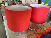 2 glass base electric table lamps with red shades