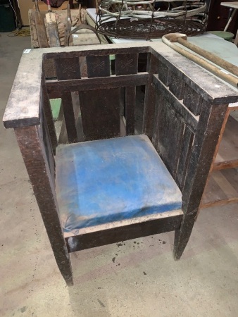 Deep-seated vintage chair with incised flower patterns on the inside