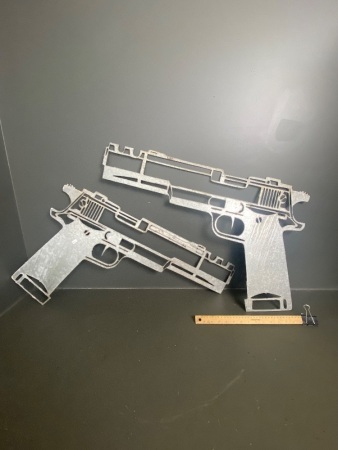 2 large Colt Handguns carved metal (80cm)