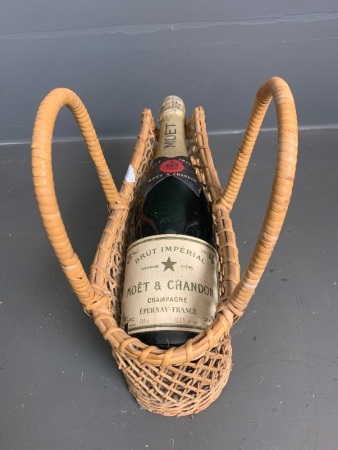 Vintage bottle of Moet & Chandon unopened in cane carry basket