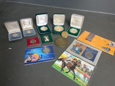 Qty commemorate coins in boxes ,including 2 x Australian 1st proof $1 coins, Don Bradman $5, 3 x royal mint coins, lady Diana marriage coin, 3 x 50cent and 1st day Melbourne cup stamp