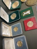 Qty commemorate coins in boxes ,including 2 x Australian 1st proof $1 coins, Don Bradman $5, 3 x royal mint coins, lady Diana marriage coin, 3 x 50cent and 1st day Melbourne cup stamp - 3