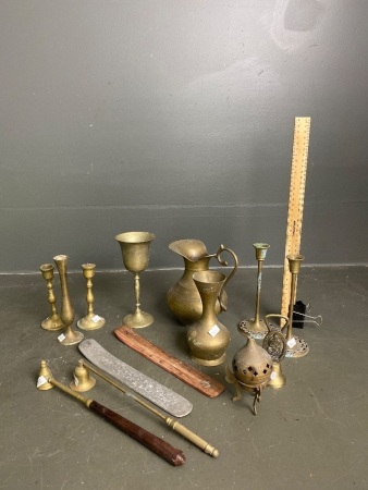 Mixed selection of brass jugs, goblets, candle holders and incence snuffs and holders