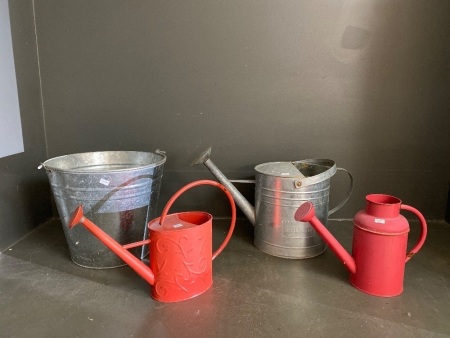 1 large metal bucket, 1 large metal watering can 2 small red metal watering cans