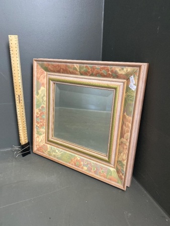 Small wooden framed mirror with floral decorations