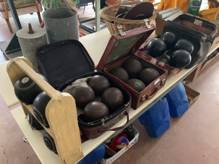 Large lot of lawn bowls, bags and rack