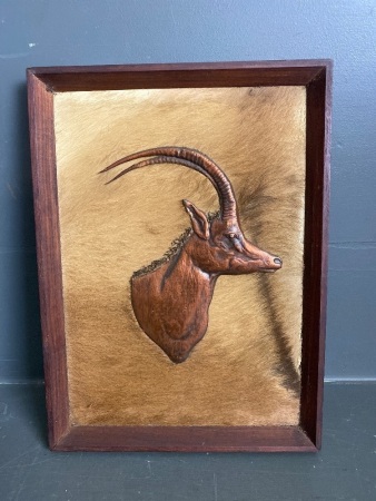 Retro brass deer head sculpture on fur back ground