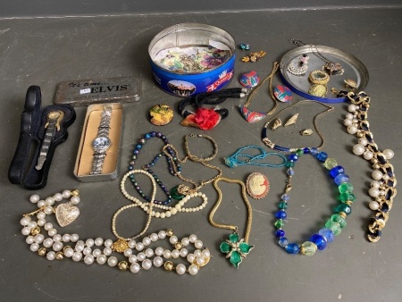 Tin full of fashion jewellery and two Elvis watches