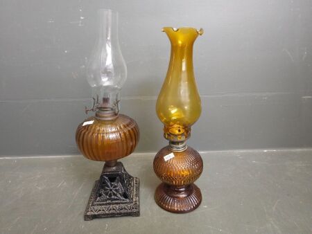 2 brown glass lanterns, one with metal base