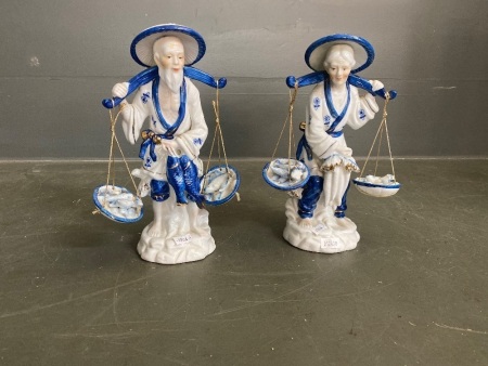 Pair of Asian ceramic figurines of old man and woman fishing