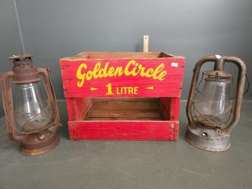 Wooden Golden Circle crate with two vintage hurricane lamps