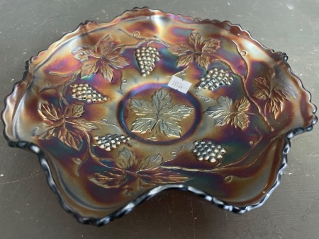 Dark carnival glass bowl with grapes