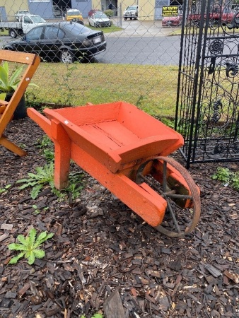 Red wooden garden wheelbarrow
