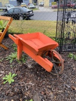 Red wooden garden wheelbarrow