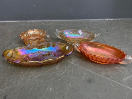 Four small carnival glass bowls