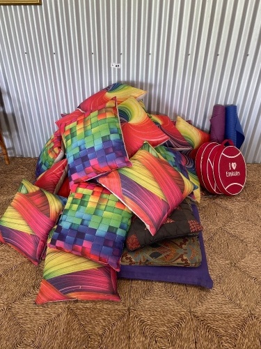 Large Qty brightly covered cushions 