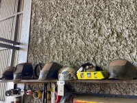 Assorted welding helmets and magnifying glasses