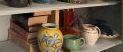 Shelf lot of books and pottery