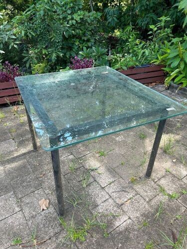 Steel framed outdoor table with heavy glass top