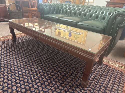 Glass topped wooden coffee table