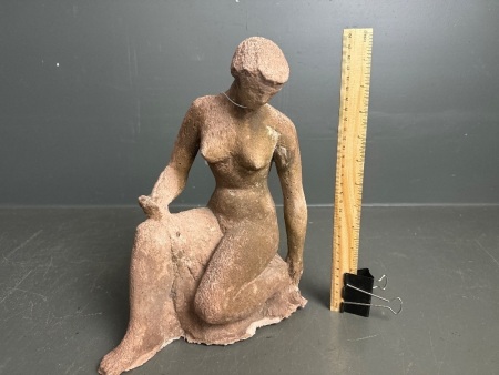 Clay sculpture of woman posing