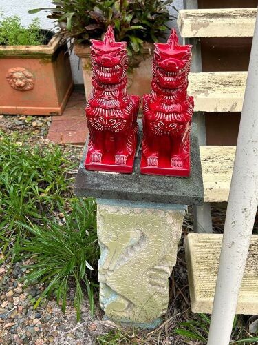 2 glazed ceramic Temple Dogs on concrete plinth