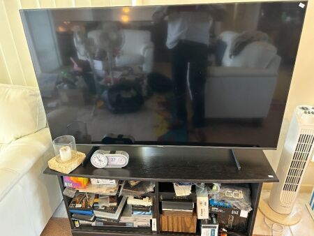 Hisense 55in flat screen television with entertainment unit, DVD player, and assorted DVDs and CDs etc