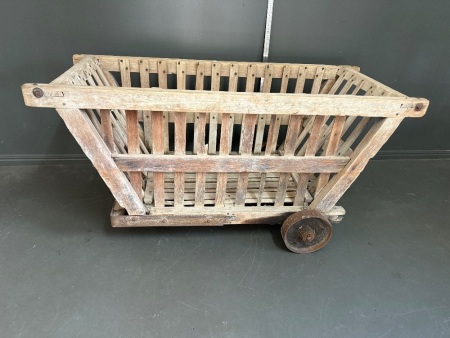 Antique wooden cart with cast iron wheels and rubber swivel wheel