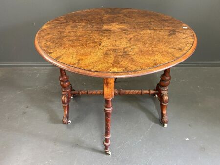 Vintage maple veneer drop leaf table with carved legs and brass/porcelain castors