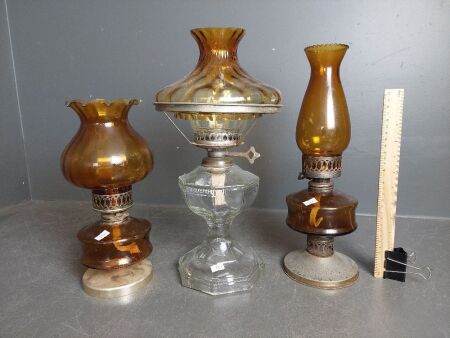 Three Amber Glass Kerosene Lanterns