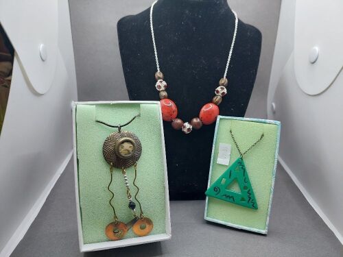 3 Necklaces - 1 Polished Wood and Ruby Trimmed - 1 Jade Triangle Pendant with Bronze Chain - 1 Retro Bronze Tone Abstact